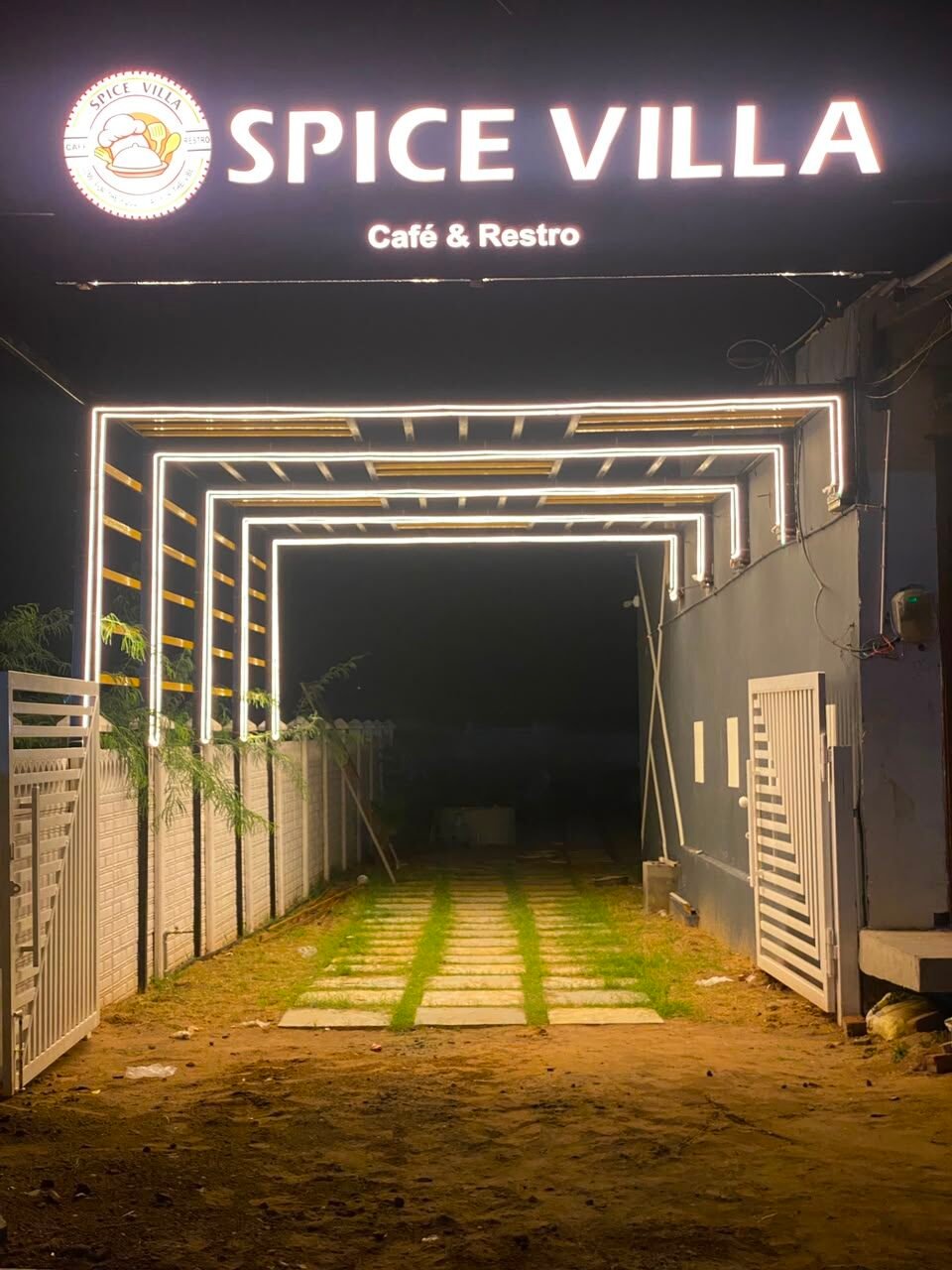 Spice Villa Café & Resto entrance lit up at night